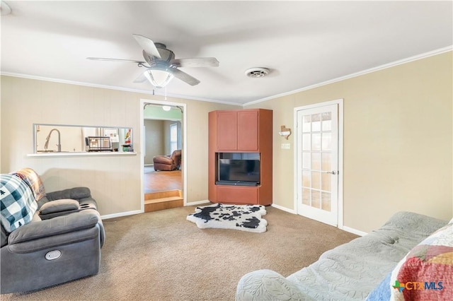 516 2nd St, Cuero, TX 77954 - living room with ornamental molding, ceiling fan, and carpet floors