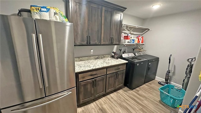 1026 County Road 3152, Kempner, TX 76539 - laundry room with washing machine and dryer, light wood finished floors, cabinet space, and baseboards