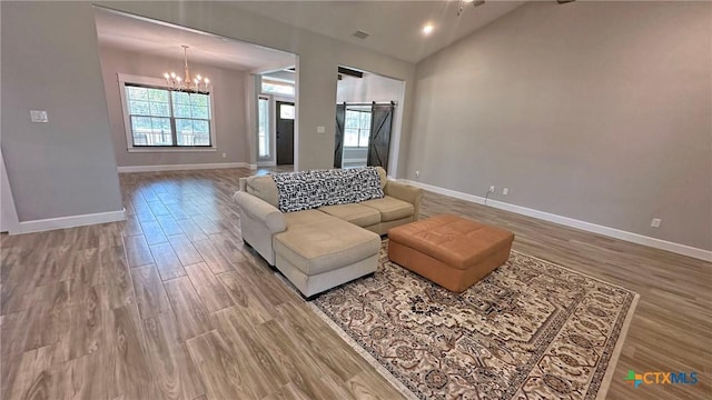 1026 County Road 3152, Kempner, TX 76539 - living area with a barn door, healthy amount of natural light, wood finished floors, and vaulted ceiling