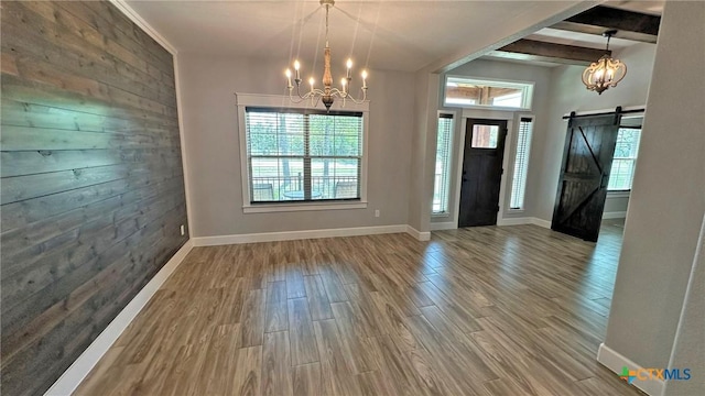 1026 County Road 3152, Kempner, TX 76539 - entryway with a chandelier, a barn door, wood finished floors, baseboards, and beam ceiling