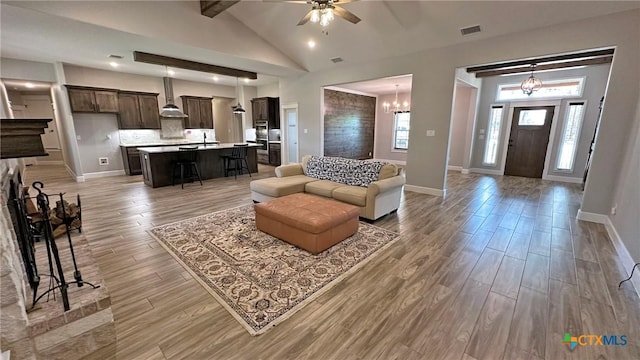 1026 County Road 3152, Kempner, TX 76539 - living area featuring a ceiling fan, baseboards, light wood-style flooring, and a chandelier