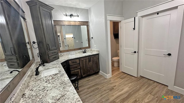 1026 County Road 3152, Kempner, TX 76539 - bathroom with vanity, toilet, wood finished floors, and baseboards