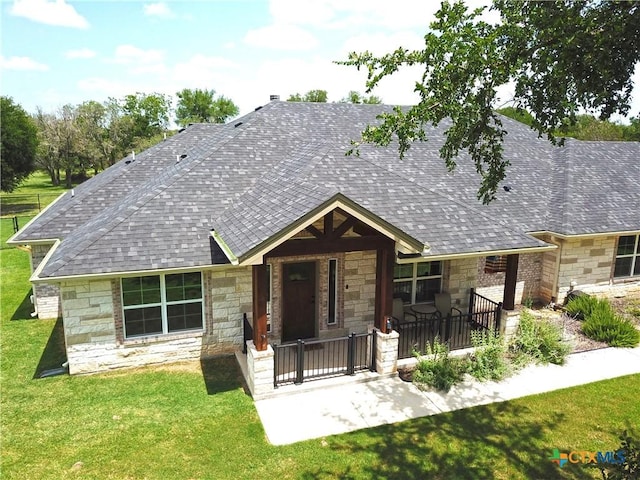 1026 County Road 3152, Kempner, TX 76539 - view of front of home with stone siding, a front yard, covered porch, and a shingled roof
