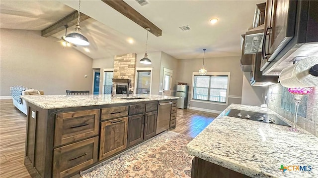 1026 County Road 3152, Kempner, TX 76539 - kitchen with dark wood-type flooring, a sink, black electric cooktop, stainless steel dishwasher, and open floor plan