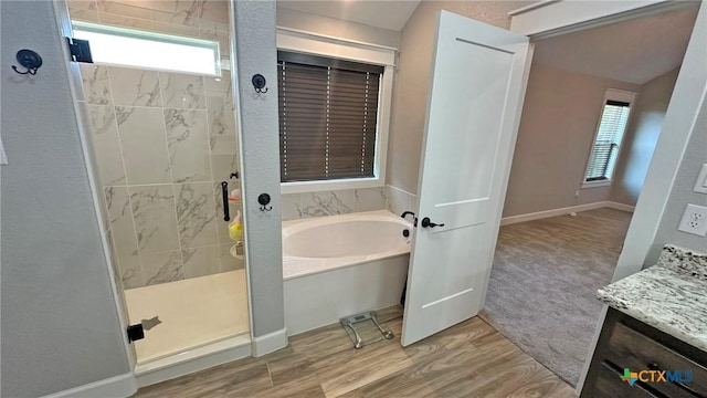 1026 County Road 3152, Kempner, TX 76539 - bathroom featuring a bath, a shower stall, vanity, and wood finished floors