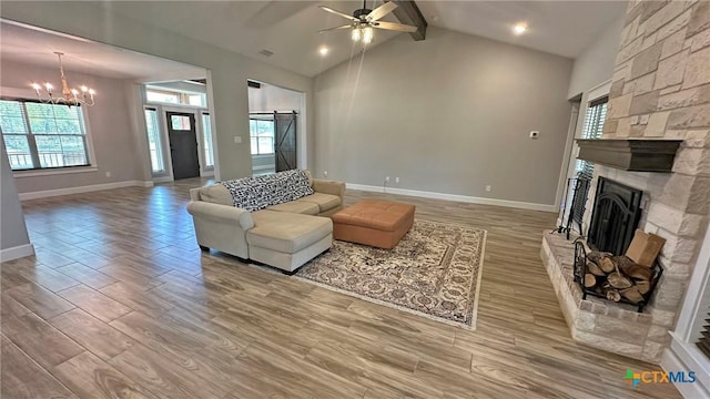 1026 County Road 3152, Kempner, TX 76539 - living room with a fireplace, light wood-type flooring, baseboards, a chandelier, and ceiling fan