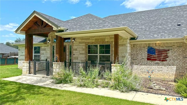 1026 County Road 3152, Kempner, TX 76539 - property entrance with a shingled roof, stone siding, and a gate