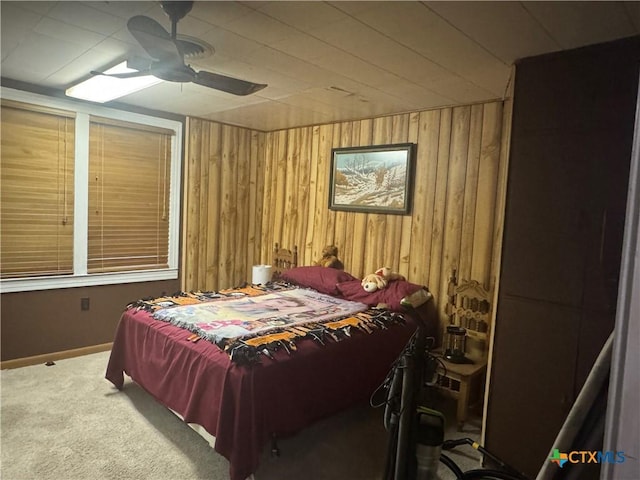 27 Wallace Ln, Victoria, TX 77904 - carpeted bedroom with wood walls, ceiling fan, and baseboards