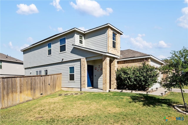 back of house featuring a yard