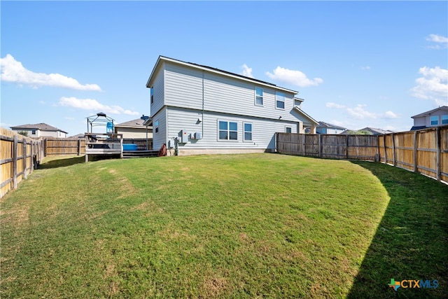 rear view of house with a lawn