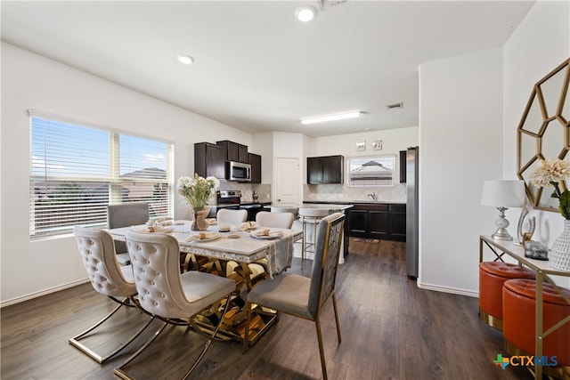 dining space featuring dark hardwood / wood-style floors and sink