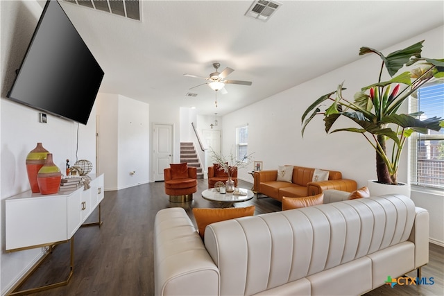 living room featuring dark hardwood / wood-style flooring and ceiling fan