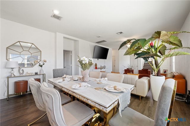 dining area with dark hardwood / wood-style flooring