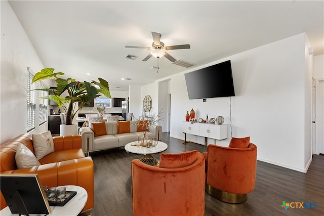 living room with dark hardwood / wood-style flooring and ceiling fan