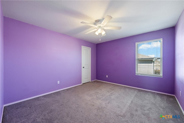 unfurnished room featuring a textured ceiling, carpet flooring, and ceiling fan