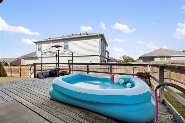 rear view of property with a wooden deck