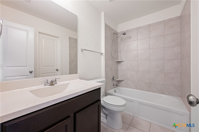 full bathroom with toilet, tiled shower / bath combo, vanity, and tile patterned floors