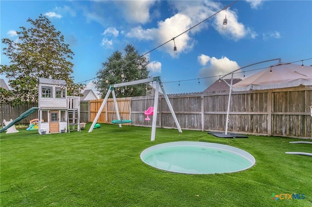 view of playground with a lawn