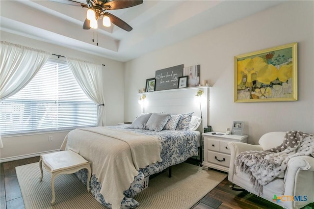 bedroom with ceiling fan and dark hardwood / wood-style flooring