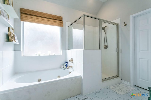 bathroom featuring lofted ceiling and shower with separate bathtub