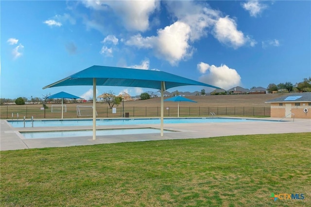 view of swimming pool with a yard