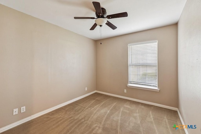 carpeted spare room featuring ceiling fan