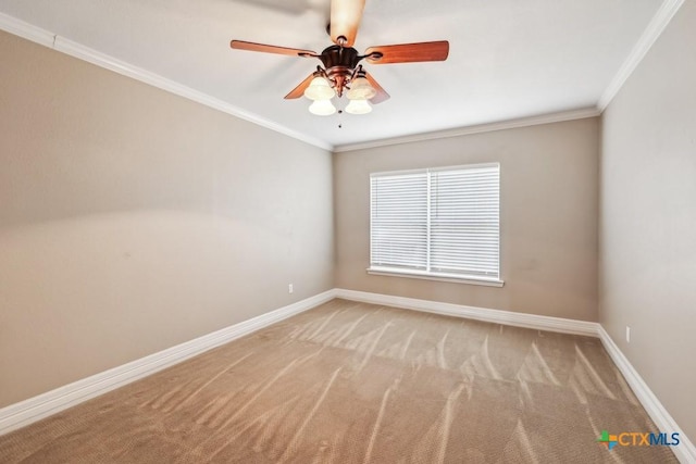 spare room featuring ceiling fan, light colored carpet, and ornamental molding