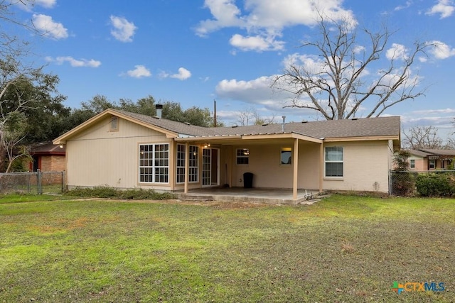 back of house with a patio and a yard