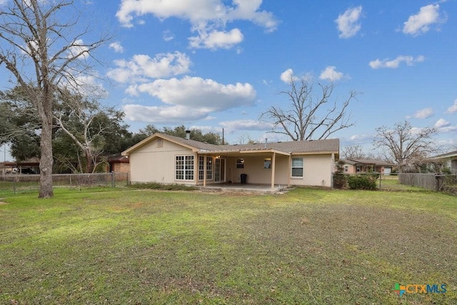 rear view of property with a patio and a yard