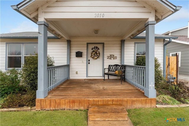 view of exterior entry featuring a porch