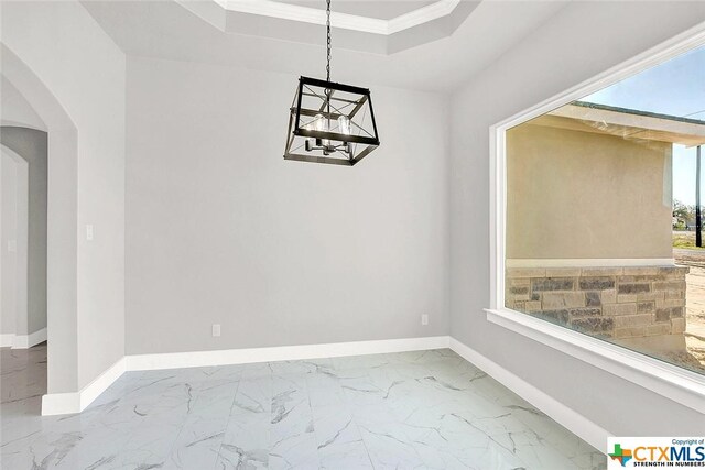 105 Hondo Rdg, La Vernia, TX 78121 - unfurnished dining area with arched walkways, a chandelier, marble finish floors, baseboards, and crown molding