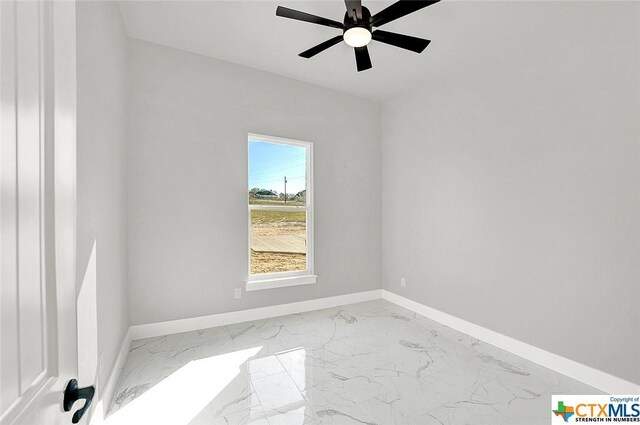 105 Hondo Rdg, La Vernia, TX 78121 - unfurnished room featuring baseboards, marble finish flooring, and ceiling fan