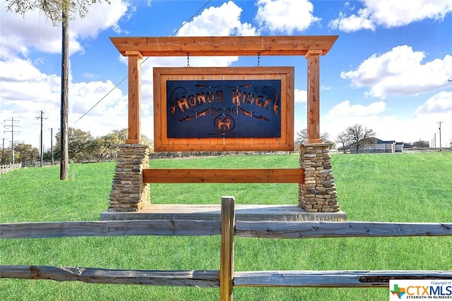 community / neighborhood sign with a yard