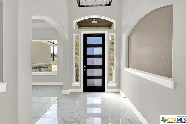 105 Hondo Rdg, La Vernia, TX 78121 - foyer featuring marble finish flooring, baseboards, and arched walkways
