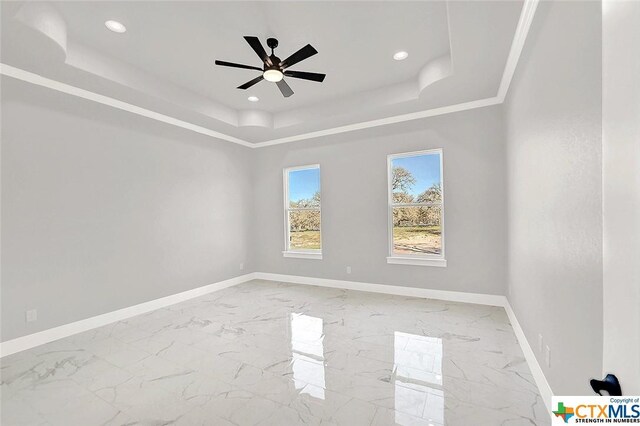 105 Hondo Rdg, La Vernia, TX 78121 - spare room with a raised ceiling, baseboards, ceiling fan, marble finish floors, and recessed lighting