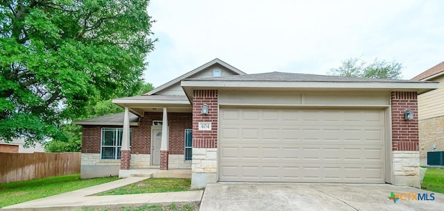 404 Chieftain Trl, Harker Heights, TX 76548 - view of front of house featuring a garage, fence, concrete driveway, and brick siding