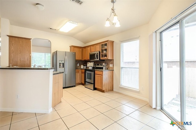 404 Chieftain Trl, Harker Heights, TX 76548 - kitchen featuring visible vents, dark countertops, lofted ceiling, glass insert cabinets, and stainless steel appliances