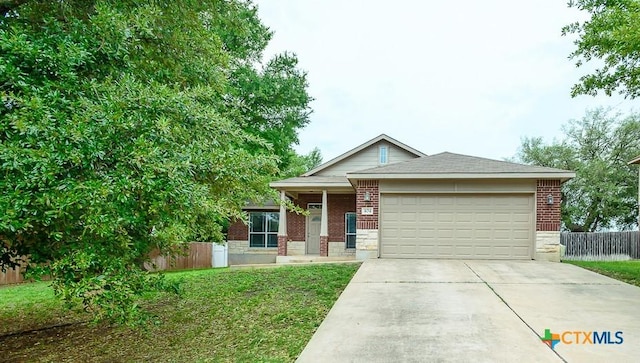 404 Chieftain Trl, Harker Heights, TX 76548 - view of front of house with driveway, a front yard, a garage, brick siding, and fence