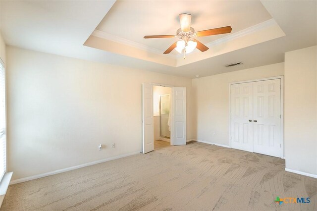 404 Chieftain Trl, Harker Heights, TX 76548 - unfurnished bedroom with light colored carpet, baseboards, a tray ceiling, and visible vents