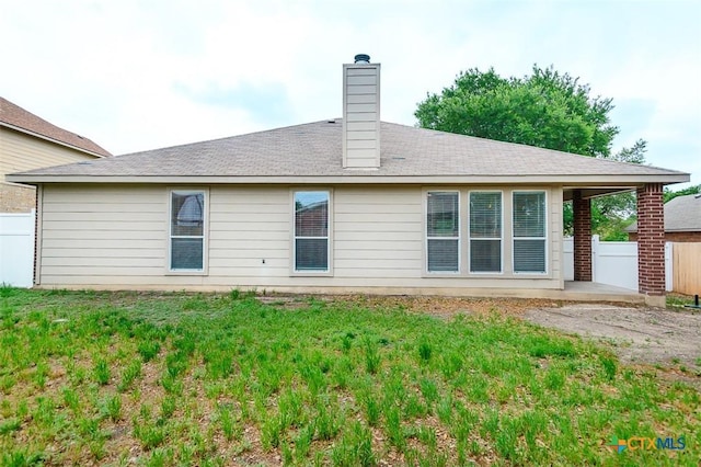 404 Chieftain Trl, Harker Heights, TX 76548 - rear view of property featuring fence, a chimney, a lawn, and a patio area