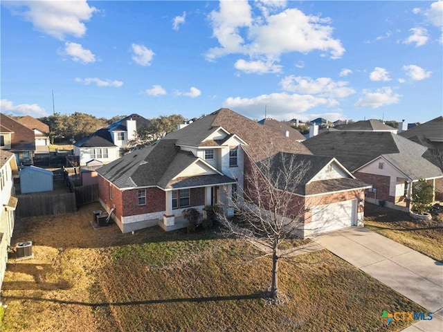 view of front of home with driveway, central AC, a residential view, an attached garage, and brick siding