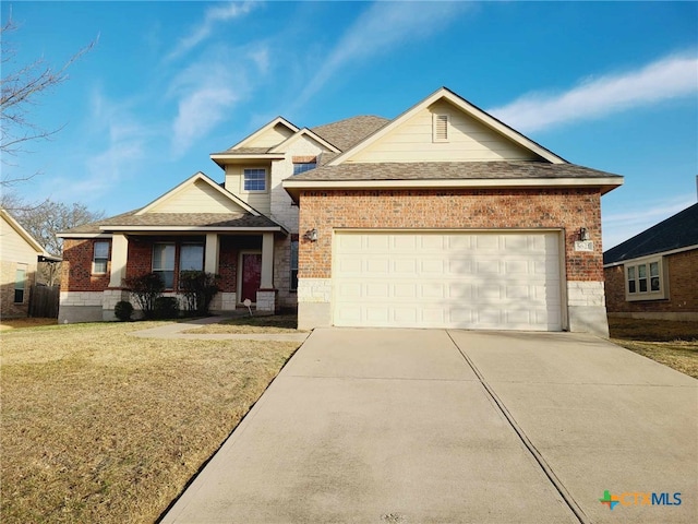 view of front facade with a garage, brick siding, and driveway