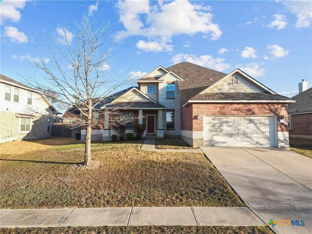 view of front of property with brick siding, a front lawn, fence, concrete driveway, and a garage