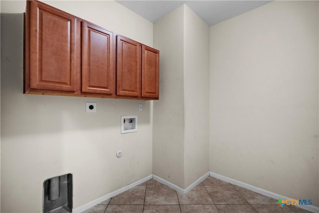 laundry area with cabinet space, light tile patterned floors, baseboards, hookup for an electric dryer, and hookup for a washing machine