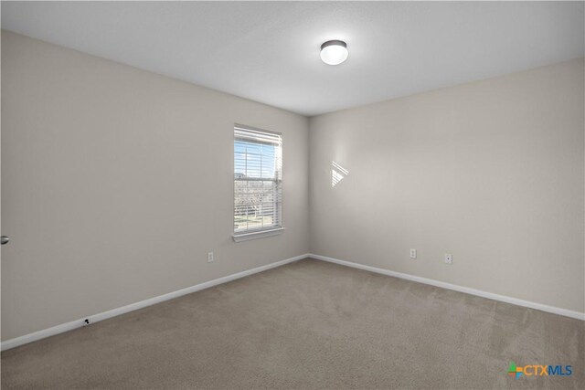 empty room with baseboards and carpet flooring