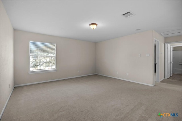 spare room featuring visible vents, baseboards, and carpet flooring