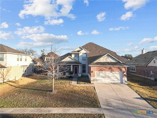 traditional-style house featuring a garage, a residential view, brick siding, and driveway