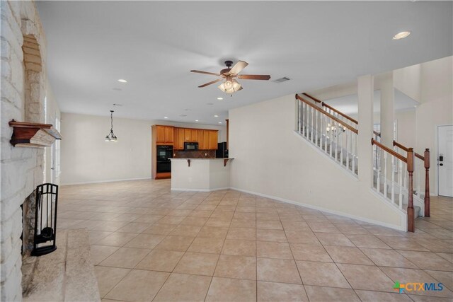 unfurnished living room with light tile patterned flooring, a fireplace, recessed lighting, ceiling fan, and stairs