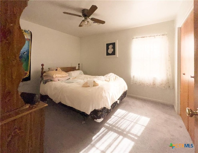 carpeted bedroom featuring a ceiling fan