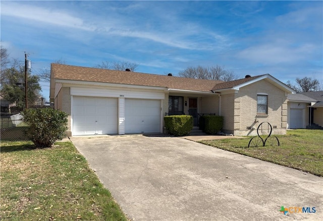 ranch-style house with brick siding, fence, a front yard, driveway, and an attached garage